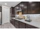 Well-appointed kitchen with dark cabinetry, stainless steel appliances, and stylish backsplash at 19606 W Grant St, Buckeye, AZ 85326