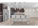 Modern kitchen with stainless steel appliances, a large island, and pendant lighting at 19606 W Grant St, Buckeye, AZ 85326
