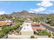 Birds-eye view of house with a red tile roof, landscaped yard, and majestic mountain views at 2016 E Orangewood Ave, Phoenix, AZ 85020