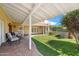 Spacious backyard patio with brick flooring, comfortable seating, and well-manicured lawn at 2016 E Orangewood Ave, Phoenix, AZ 85020