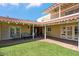 Spacious covered patio area with comfortable seating, brick flooring, and a well-manicured lawn at 2016 E Orangewood Ave, Phoenix, AZ 85020