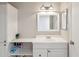 Clean bathroom featuring white cabinetry, a sink, and built-in storage shelves at 2016 E Orangewood Ave, Phoenix, AZ 85020