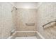 Standard bathroom featuring unique mosaic tiling in shower area with support handles at 2016 E Orangewood Ave, Phoenix, AZ 85020