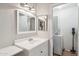 Practical bathroom with a single sink vanity and laundry room access at 2016 E Orangewood Ave, Phoenix, AZ 85020