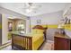 Comfortable bedroom with yellow bedding, bright wall colors, and ample natural light at 2016 E Orangewood Ave, Phoenix, AZ 85020