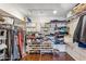 Walk-in closet with custom shelving and racks for organized storage at 2016 E Orangewood Ave, Phoenix, AZ 85020