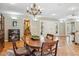 Warm and inviting dining room featuring terracotta tile flooring, neutral paint and a elegant chandelier at 2016 E Orangewood Ave, Phoenix, AZ 85020