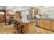 Spacious kitchen with granite countertops, stainless steel appliances, and a brick fireplace at 2016 E Orangewood Ave, Phoenix, AZ 85020