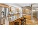 Modern kitchen features a spacious island with bar seating, stainless steel appliances, and ample counter space at 2016 E Orangewood Ave, Phoenix, AZ 85020