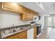 Functional kitchen featuring wood cabinets, tile floors, and modern appliances at 2016 E Orangewood Ave, Phoenix, AZ 85020