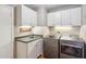 Convenient laundry room with modern washer, dryer and sink with a countertop at 2016 E Orangewood Ave, Phoenix, AZ 85020