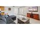 Relaxing living room with a comfortable couch, tile floors, and bright shutters at 2016 E Orangewood Ave, Phoenix, AZ 85020