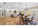 Open floor plan featuring dining and living areas with terracotta tile floors, neutral walls and a view to the exterior at 2016 E Orangewood Ave, Phoenix, AZ 85020