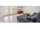 Inviting living room with a comfortable couch, tile floors, and bright shutters at 2016 E Orangewood Ave, Phoenix, AZ 85020