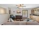 Cozy living room features hardwood floors, neutral-toned sofa with throw pillows, and an adjacent kitchenette at 2016 E Orangewood Ave, Phoenix, AZ 85020