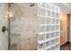 Shower featuring glass block partition, and tile walls at 2016 E Orangewood Ave, Phoenix, AZ 85020