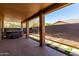 Covered patio with hot tub and landscaped backyard with synthetic grass at 20670 N 41St Ave, Glendale, AZ 85308