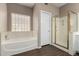 Bathroom showcasing a tub, shower, and glass block window for natural light at 20670 N 41St Ave, Glendale, AZ 85308