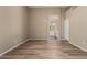 Large bedroom featuring wood-look floors and an arched doorway leading to the bathroom at 20670 N 41St Ave, Glendale, AZ 85308