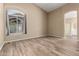 Spacious bedroom featuring wood-look floors, neutral paint, and a large arched window at 20670 N 41St Ave, Glendale, AZ 85308