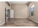 Bright bedroom with wood-look floors and a large window overlooking the neighborhood at 20670 N 41St Ave, Glendale, AZ 85308