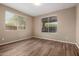 Bedroom featuring wood-look floors and large windows providing natural light at 20670 N 41St Ave, Glendale, AZ 85308