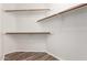 Walk-in closet featuring wood-look floors and wood closet rods for ample storage space at 20670 N 41St Ave, Glendale, AZ 85308