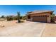 Attached garage door with decorative windows and stone trim, set against a desert backdrop at 20670 N 41St Ave, Glendale, AZ 85308