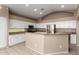 Bright eat-in kitchen featuring an island, white cabinets, granite counters and stainless-steel appliances at 20670 N 41St Ave, Glendale, AZ 85308