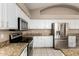 Well-equipped kitchen with white cabinets, granite countertops, stainless steel appliances, and tile flooring at 20670 N 41St Ave, Glendale, AZ 85308