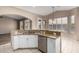 Charming kitchen featuring white cabinets, stainless steel appliances, and granite countertops at 20670 N 41St Ave, Glendale, AZ 85308