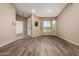 Spacious living room with wood-look floors, large bay windows, and neutral paint at 20670 N 41St Ave, Glendale, AZ 85308