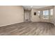 Bright living room featuring wood-look floors, a bay window, and views to the front yard at 20670 N 41St Ave, Glendale, AZ 85308