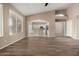 Open living room with wood-look floors flows into kitchen area with stainless appliances and views to outdoors at 20670 N 41St Ave, Glendale, AZ 85308