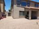 View of spacious backyard with gravel, covered patio, and lush greenery at 2317 E Mohave Ln, Apache Junction, AZ 85119