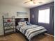 Stylish bedroom with unique artwork, striped bedding, and natural light at 2317 E Mohave Ln, Apache Junction, AZ 85119