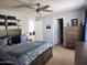 Comfortable bedroom with soft blue tones and ample storage in dresser and closet at 2317 E Mohave Ln, Apache Junction, AZ 85119