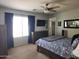 Bright bedroom showcasing a bed with patterned bedding and a ceiling fan at 2317 E Mohave Ln, Apache Junction, AZ 85119