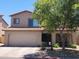 Charming two-story home featuring a lush shade tree and a convenient two-car garage at 2317 E Mohave Ln, Apache Junction, AZ 85119