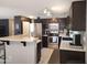 Modern kitchen featuring dark cabinets, stainless steel appliances, and a breakfast bar at 2317 E Mohave Ln, Apache Junction, AZ 85119