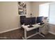 This home office includes dual monitors, an adjustable desk, and themed artwork at 2317 E Mohave Ln, Apache Junction, AZ 85119