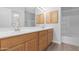 Bathroom with double sinks, wood cabinets, and a shower-tub combo at 2565 S Signal Butte Rd # 30, Mesa, AZ 85209