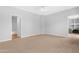 Spacious bedroom featuring neutral walls, plush carpeting, a ceiling fan and an attached walk-in closet at 2565 S Signal Butte Rd # 30, Mesa, AZ 85209
