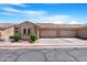 Inviting exterior of a single-story home with a two-car garage, desert landscaping, and a tile roof at 2565 S Signal Butte Rd # 30, Mesa, AZ 85209
