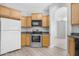 Well-equipped kitchen with stainless steel appliances, ample wood cabinetry, and a view to the living area at 2565 S Signal Butte Rd # 30, Mesa, AZ 85209