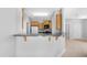 Kitchen featuring dark appliances, light wood cabinets, and an open breakfast bar at 2565 S Signal Butte Rd # 30, Mesa, AZ 85209