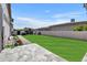 A beautifully landscaped backyard features a lush lawn, patio, and block wall at 2652 E Pelican Ct, Gilbert, AZ 85297
