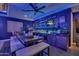 Custom home bar with a TV, shelving with glassware, and seating, perfect for entertaining at 2652 E Pelican Ct, Gilbert, AZ 85297