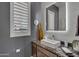 Stylish bathroom with modern vanity, decorative mirror, and elegant fixtures at 2652 E Pelican Ct, Gilbert, AZ 85297