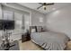 Cozy bedroom with a ceiling fan, window shutters, and a comfortable bed at 2652 E Pelican Ct, Gilbert, AZ 85297